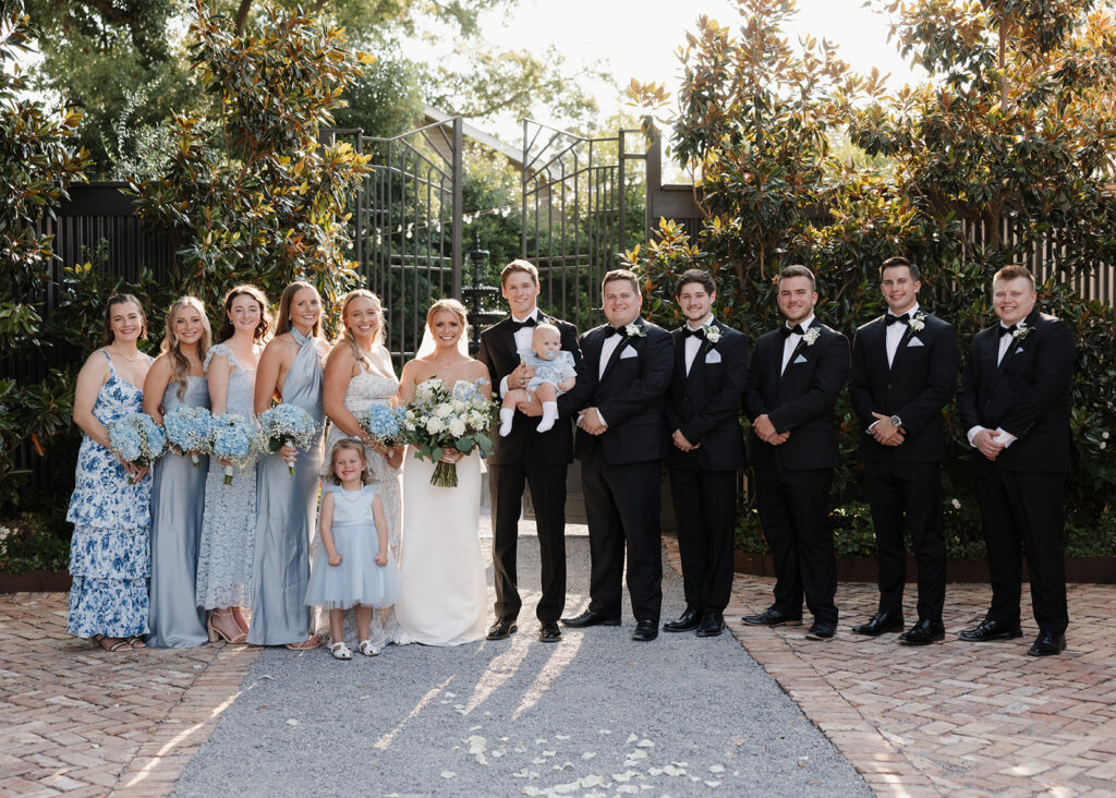 bride, groom, and bridal party smile