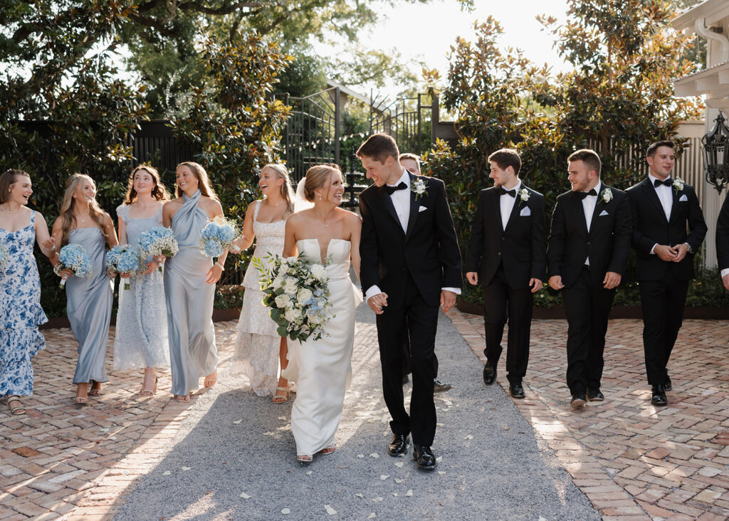  bride, groom, and wedding party walk