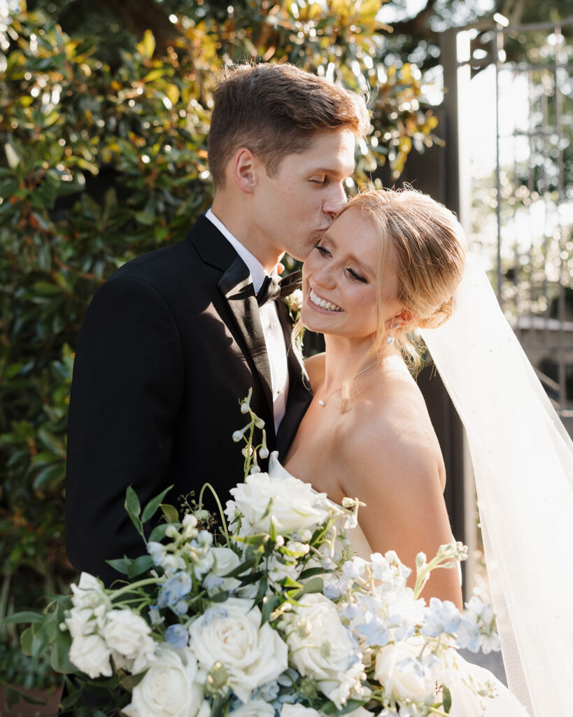 groom kisses bride's cheek