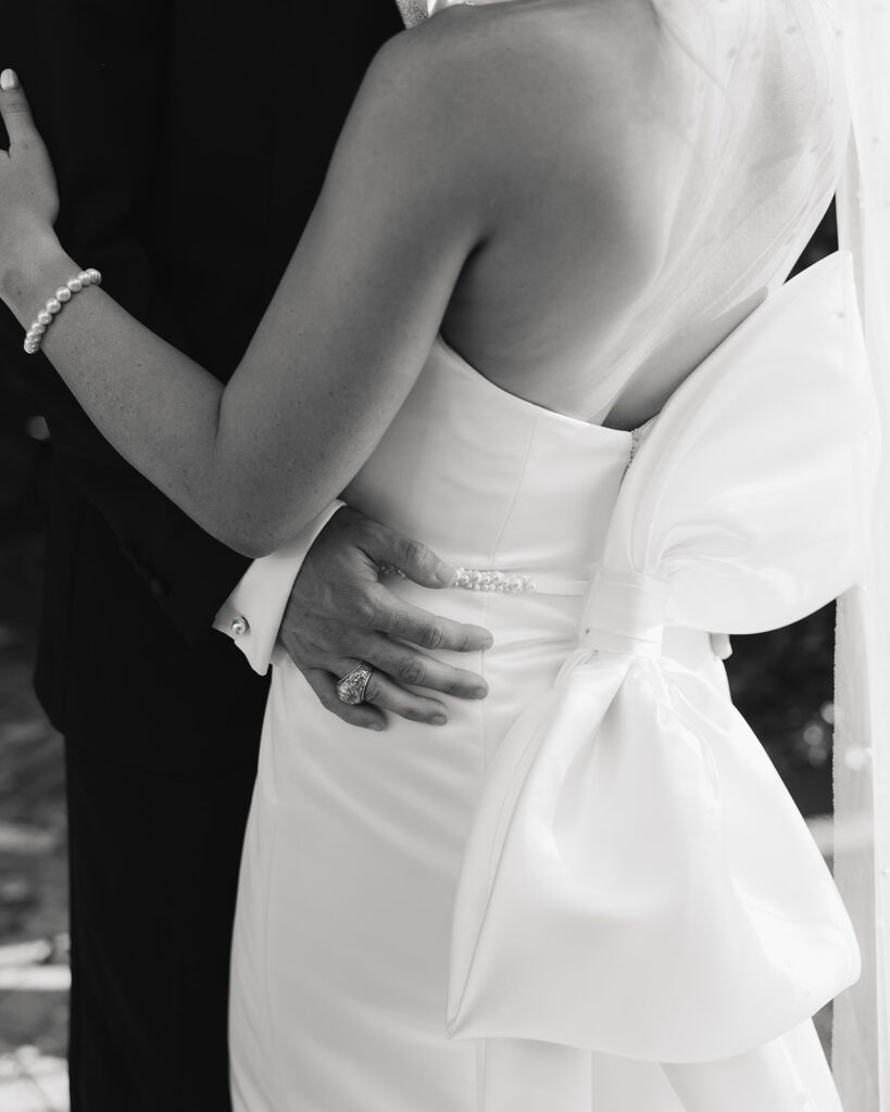 groom holds bride's waist