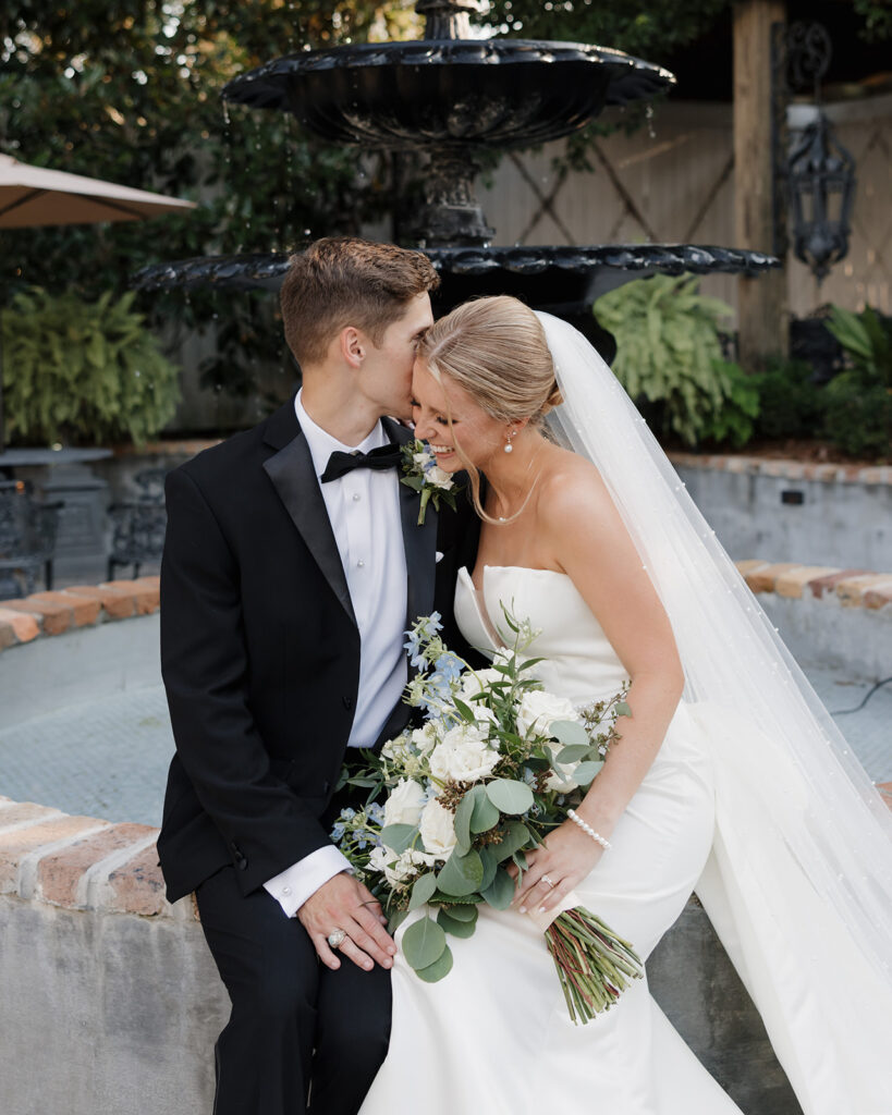 groom whispers into bride's ear