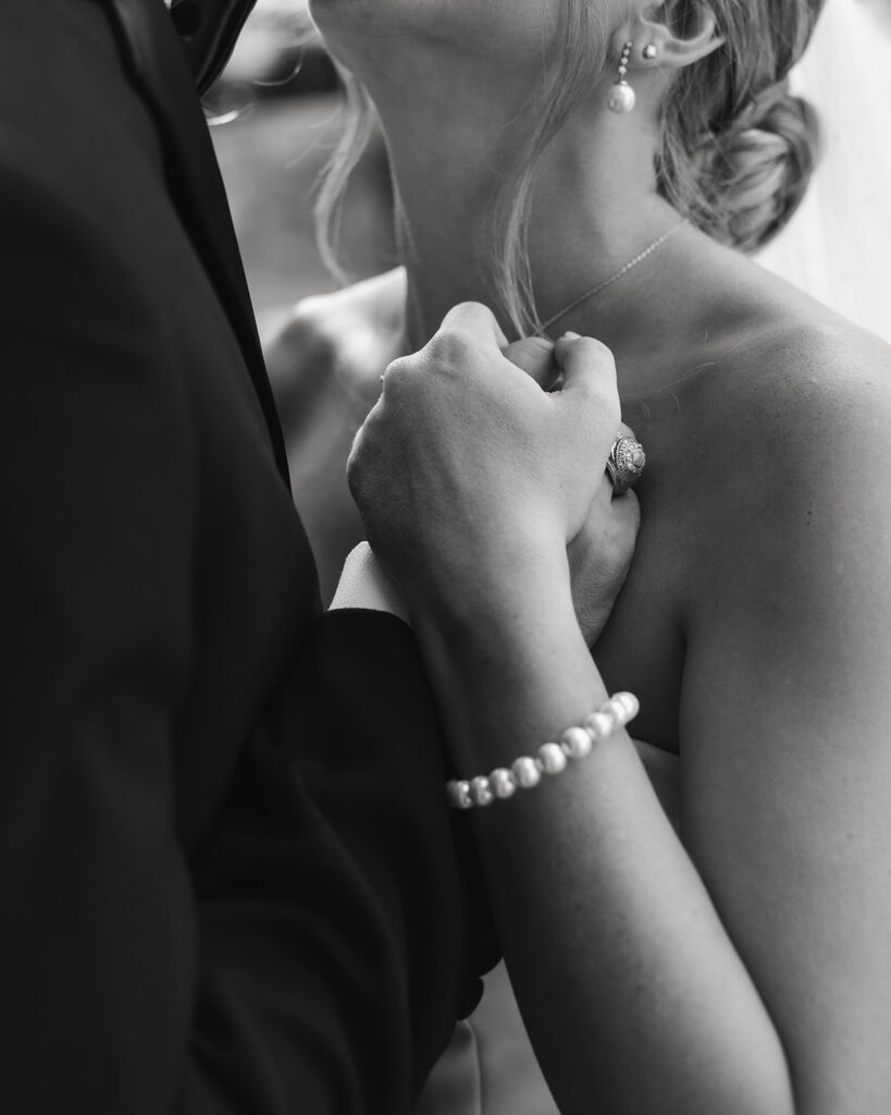 bride and groom hold each other close