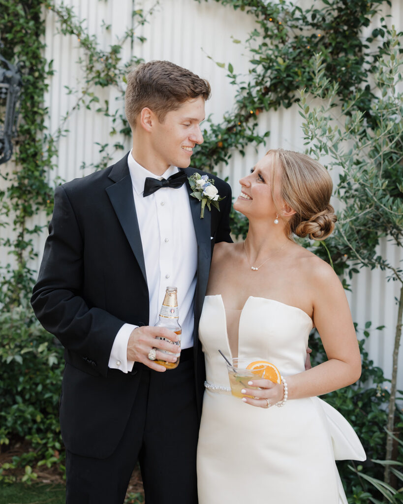 bride and groom share a drink