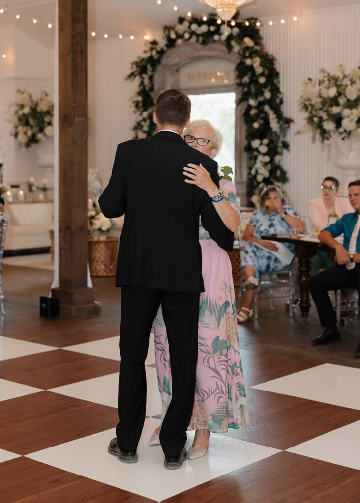 mother of the groom dances with the groom