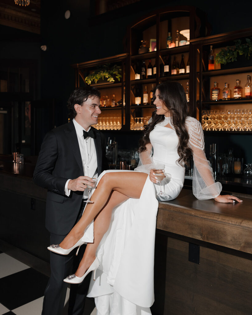 bride and groom talk at a bar