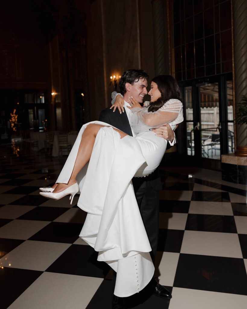 groom carries bride