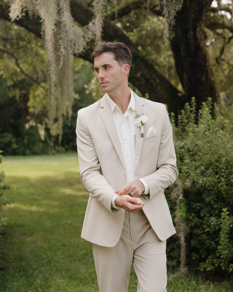 groom fixes his sleeves