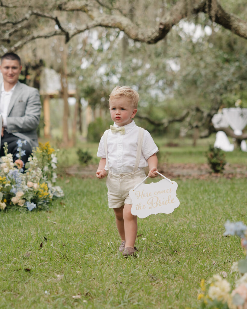 ring bearer walks down the aisle