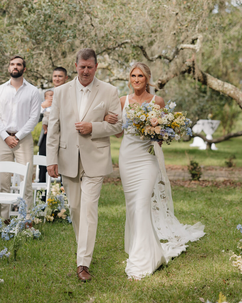 bride and her father walk down the aisle