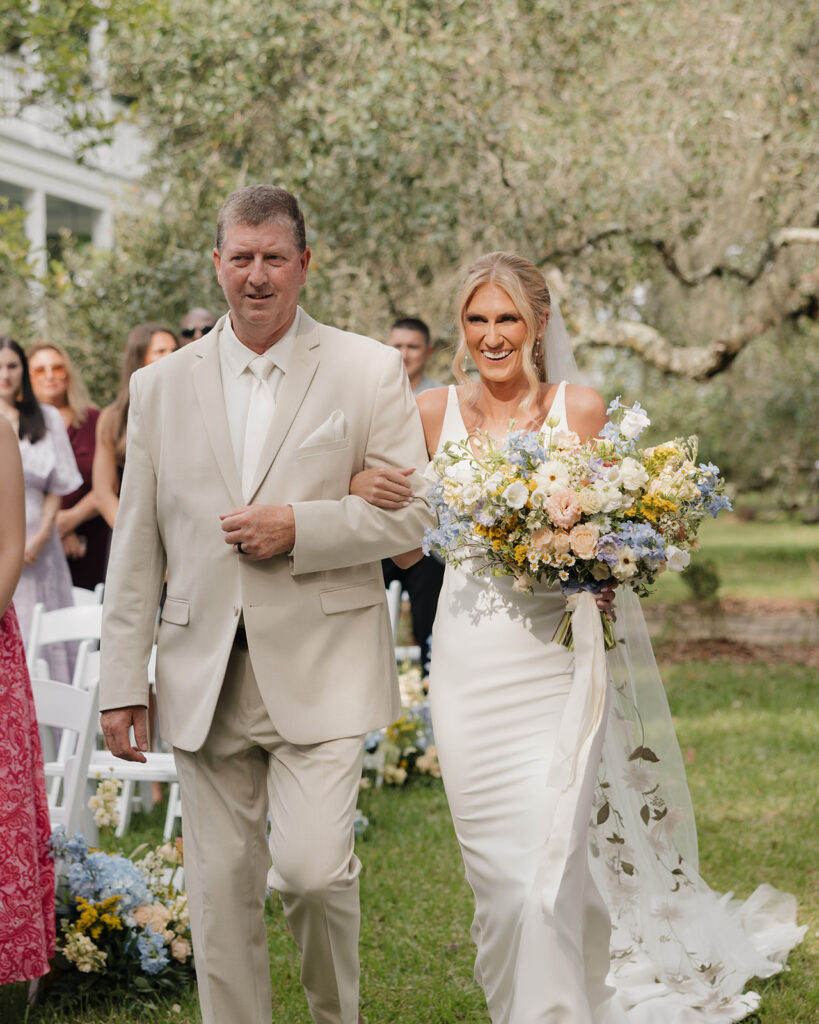 bride and her father walk down the aisle