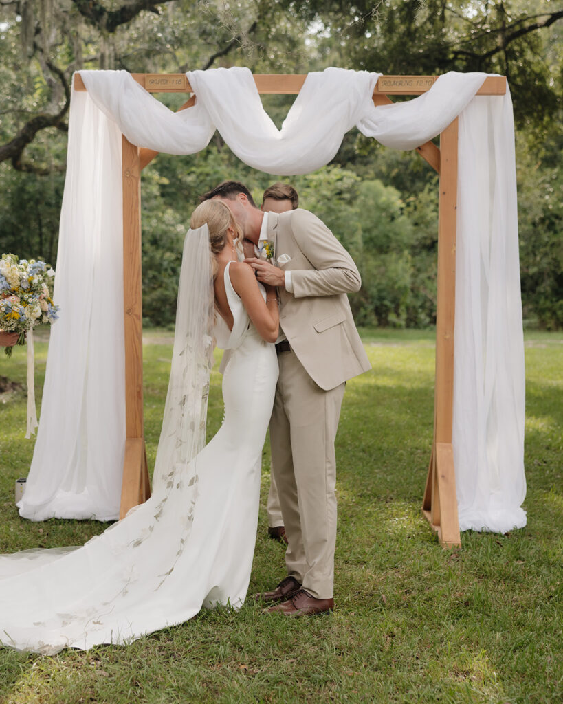 bride and groom share their first kiss