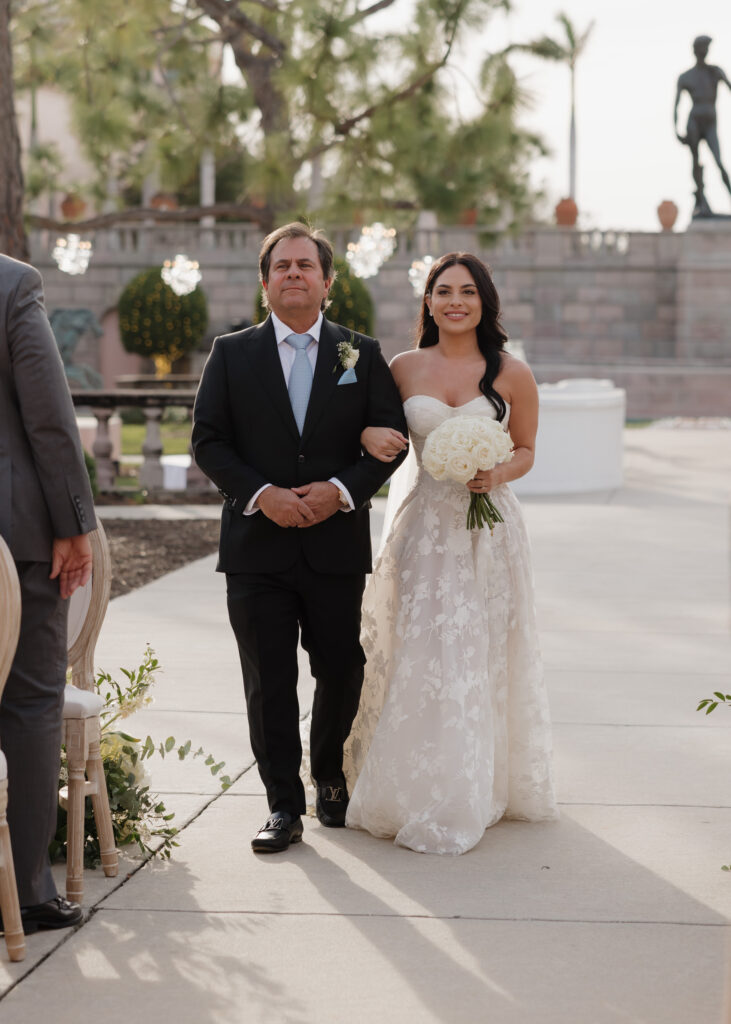 bride and her father walk down the aisle