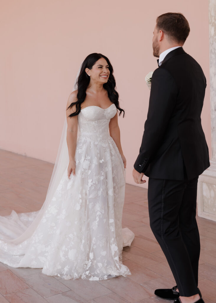 bride smiles as she sees her groom