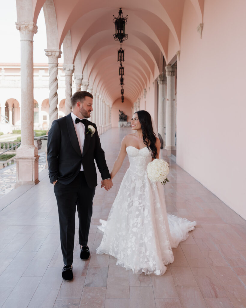 bride and groom walk through the Ringling Museum