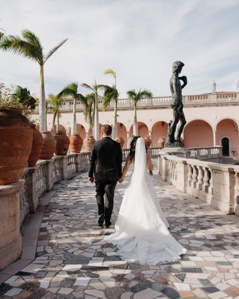 bride and groom walk past the David statue