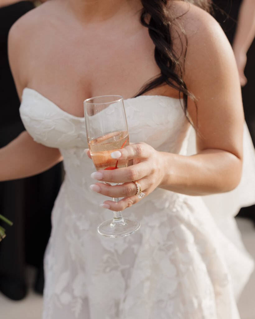 bride drinks prosecco with a cherry