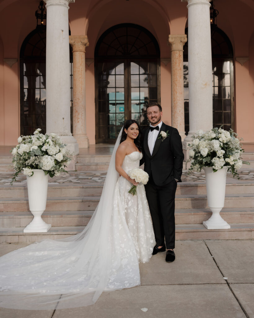 bride and groom stand in front of the Ringling