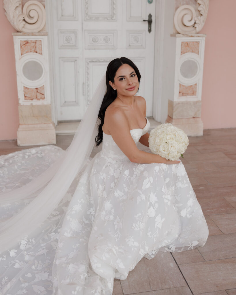 Bride smiles as she kneels