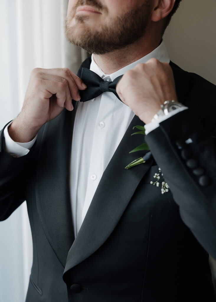 At the Westin hotel, the groom adjusts his bowtie