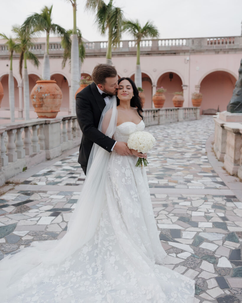 groom kisses bride's cheek