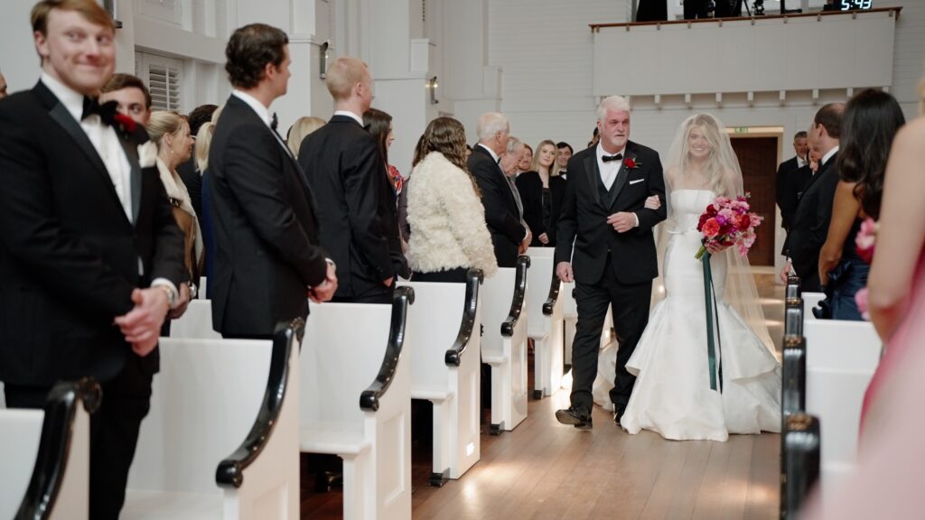 bride walks down the aisle at the chapel at Seaside