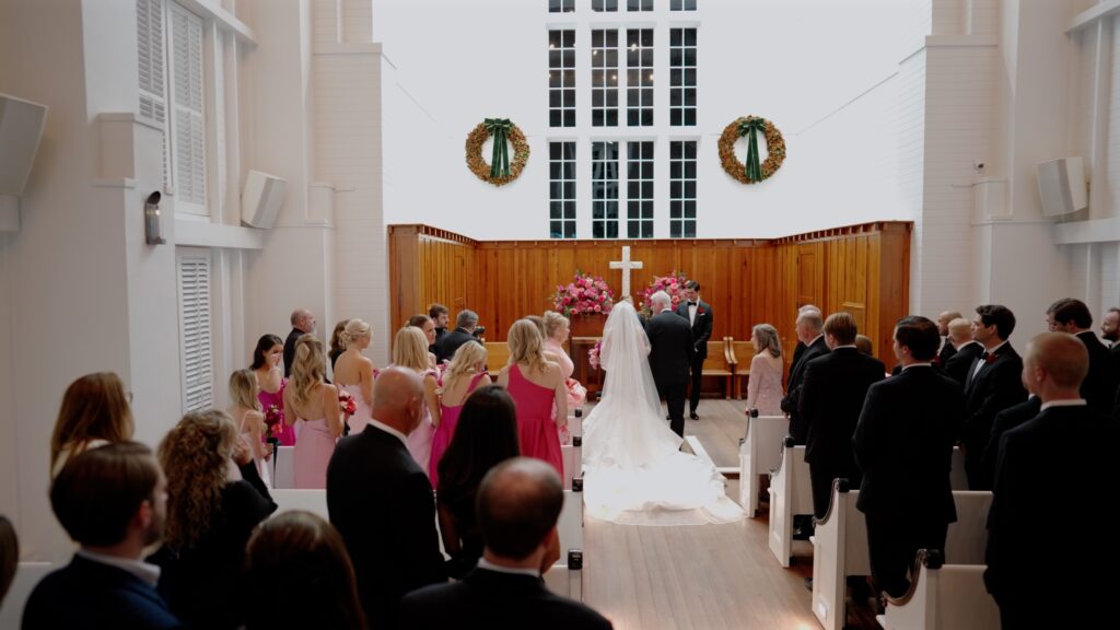 bride walks down the aisle in the Chapel at Seaside