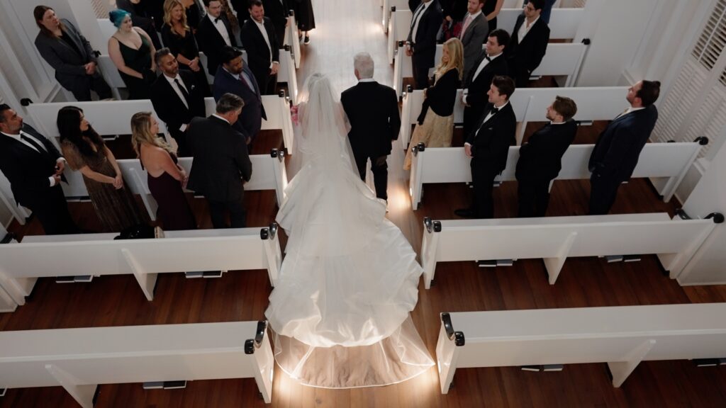 Bride walks down the aisle at the chapel at Seaside