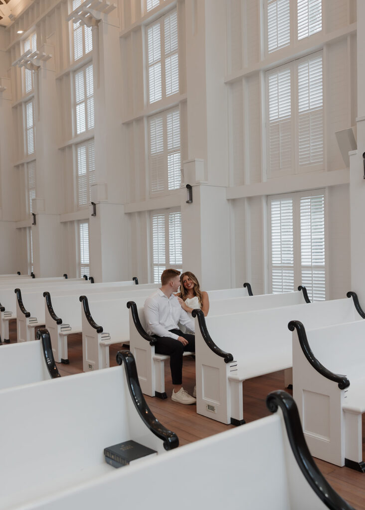 man and woman sit in a pew at the Seaside Chapel