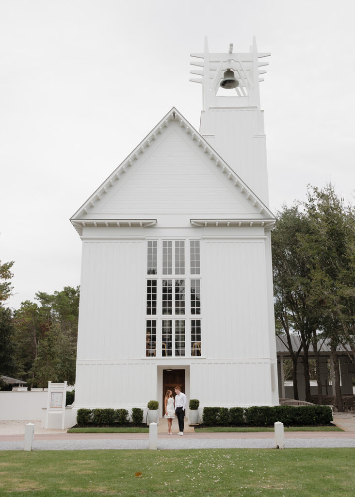 bride and groom stand by the Seaside Chapel