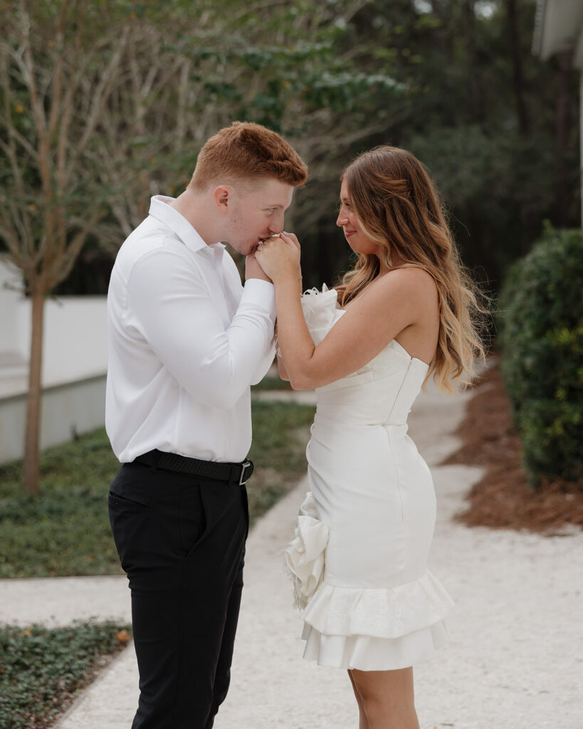 man kisses woman's hands