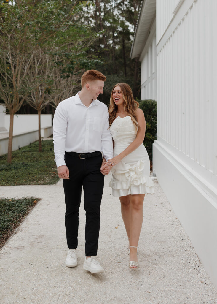 man and woman hold hands and walk