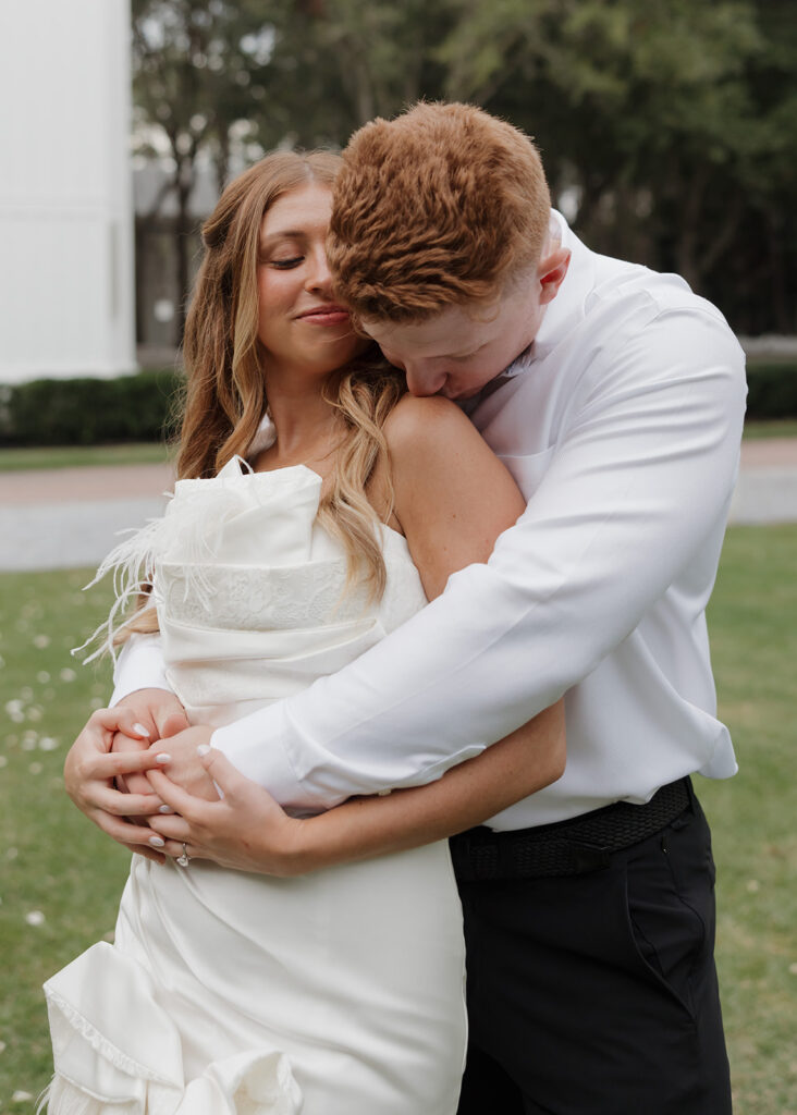 man kisses woman's shoulder