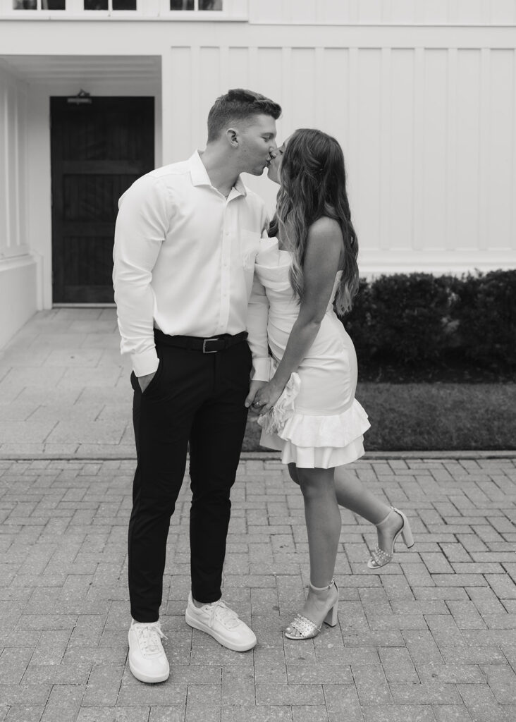 bride and groom kiss by the chapel doors