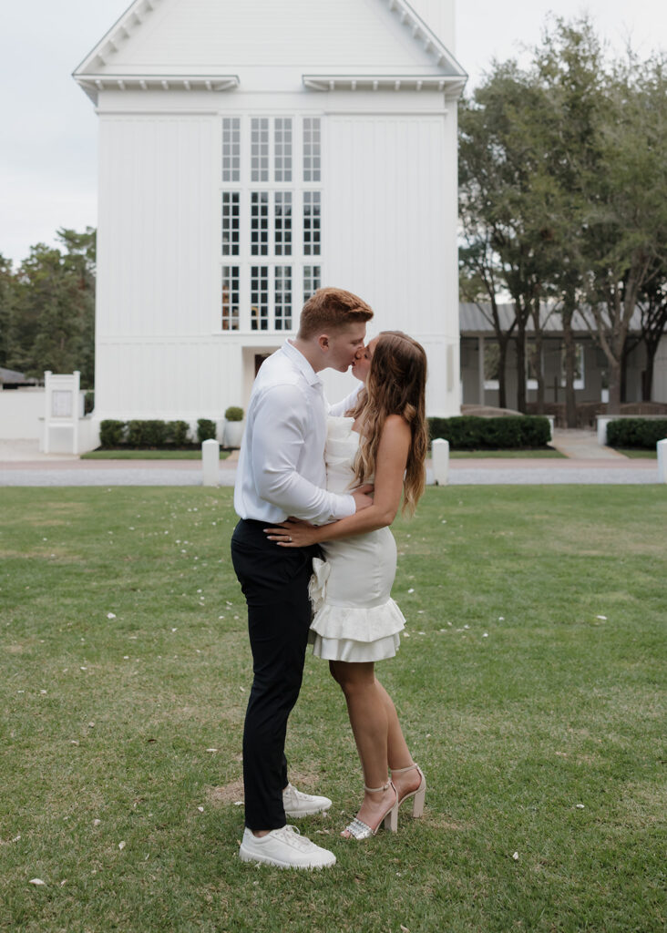 man and woman kiss in front of the Seaside Chapel