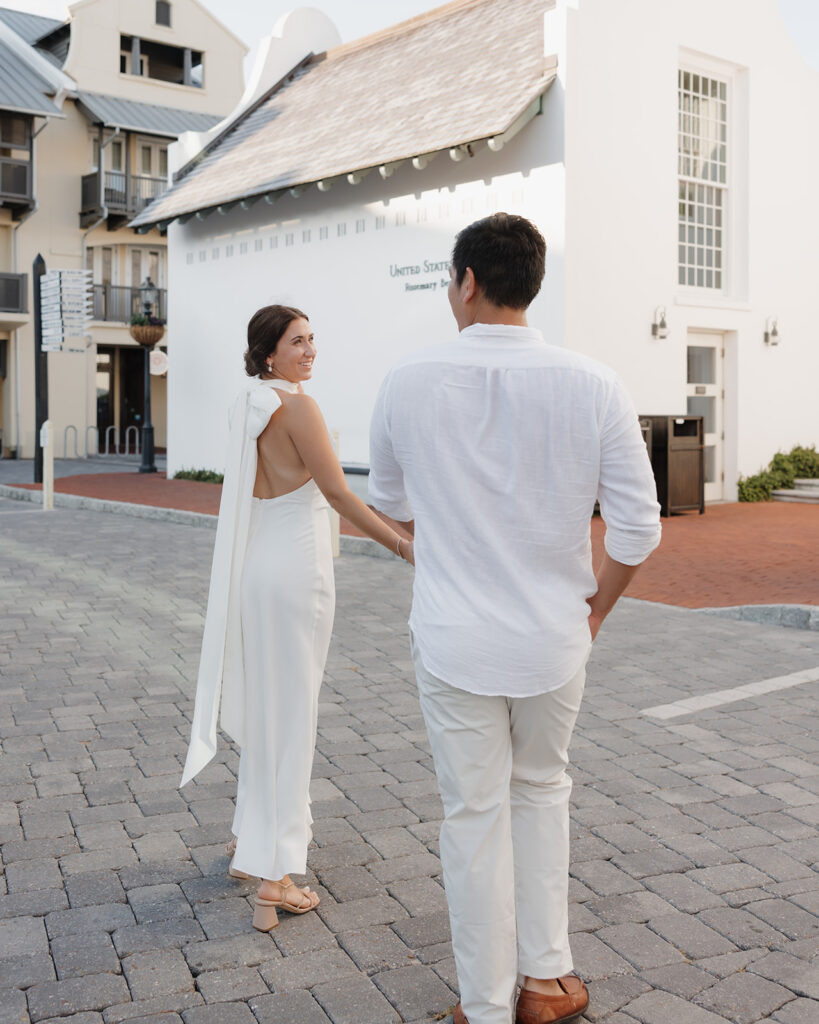 woman and man walk through Rosemary beach