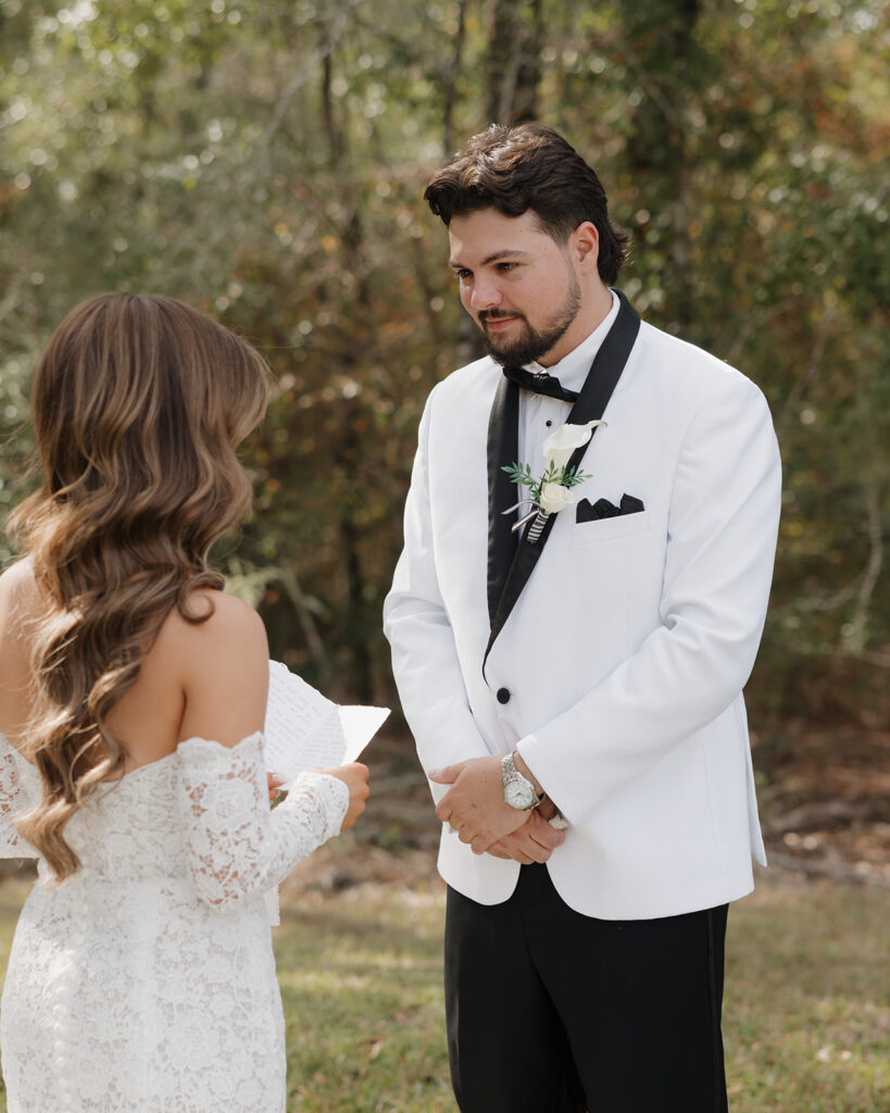 groom listens to vows being read