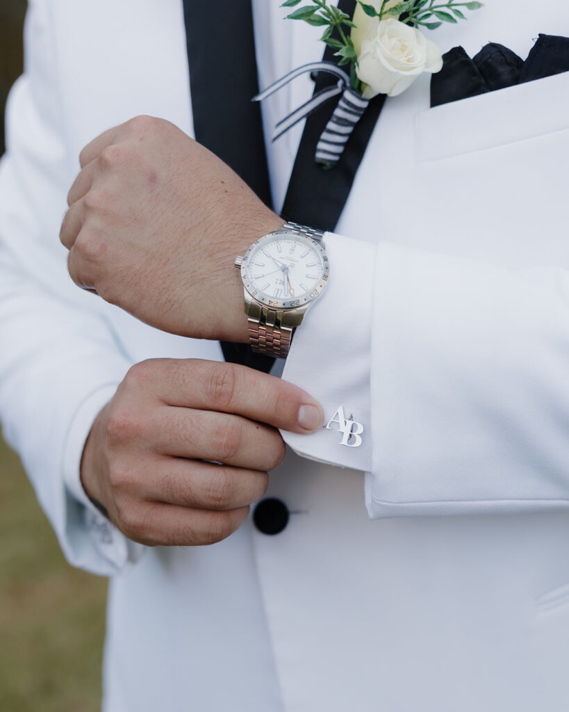 groom adjusts his cufflinks