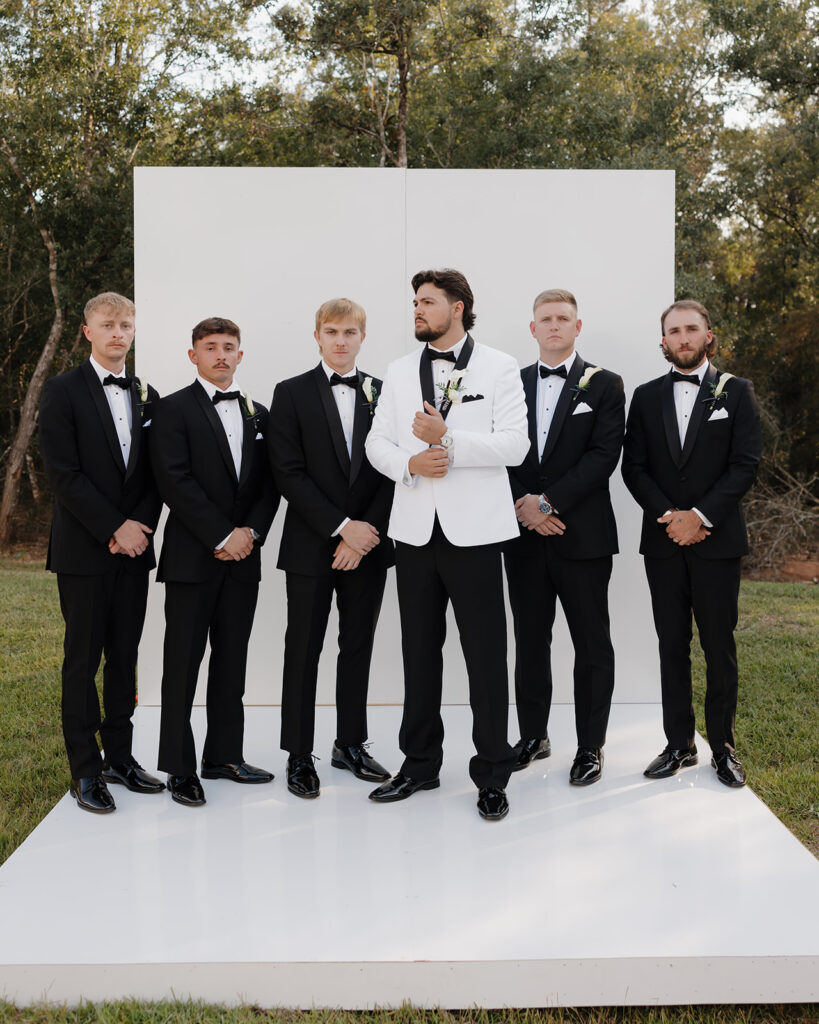 groom adjusts his sleeves