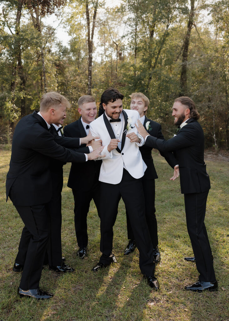 groomsmen and groom laugh