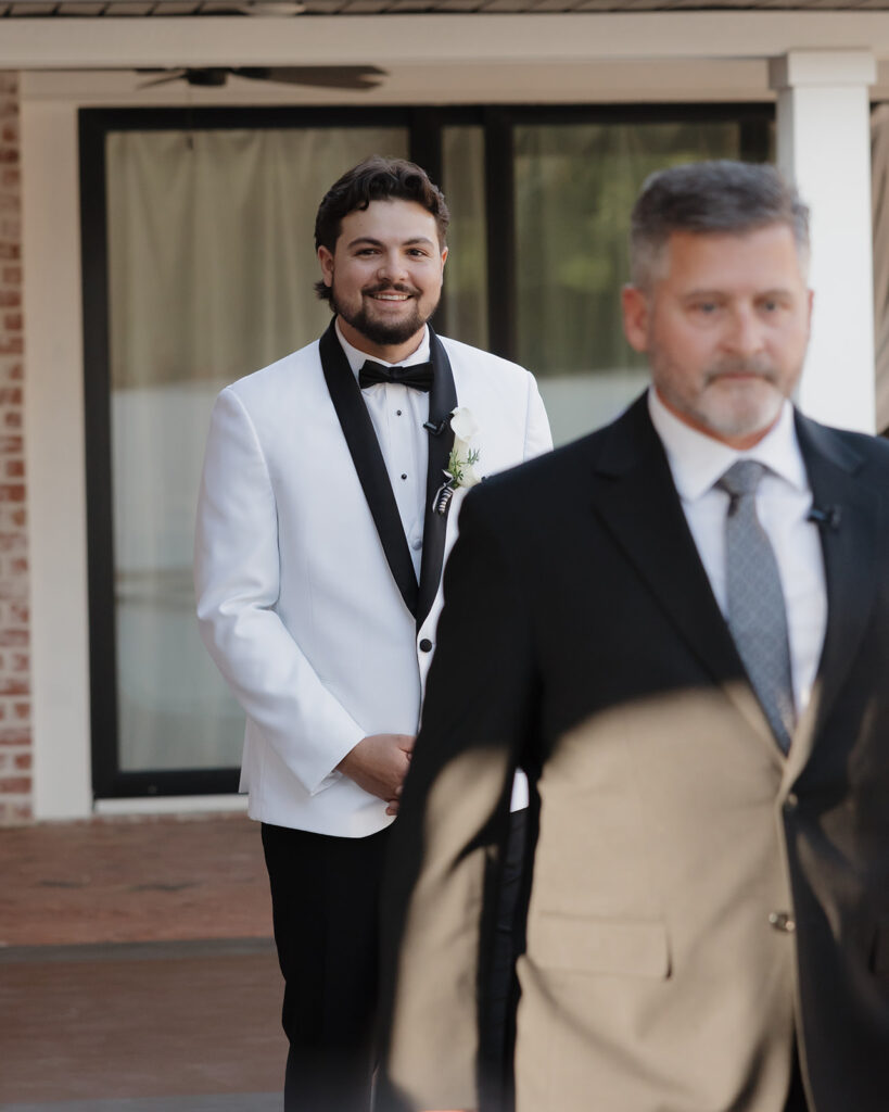 groom walks down the aisle