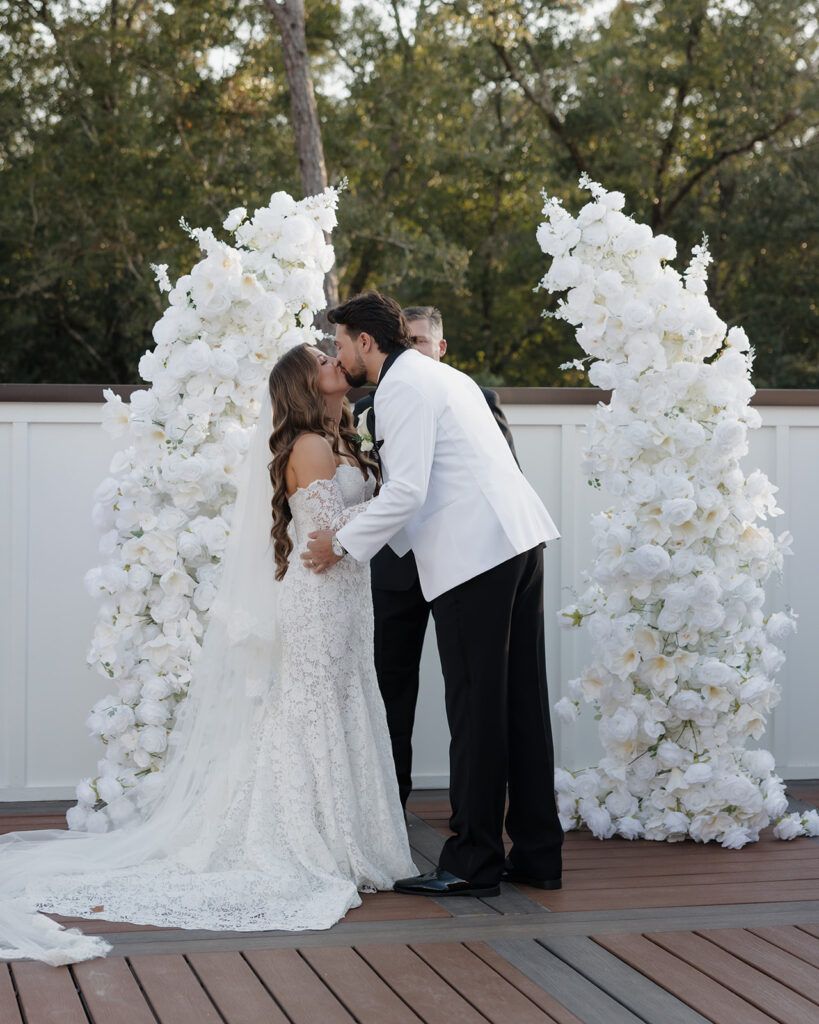 bride and groom share first kiss