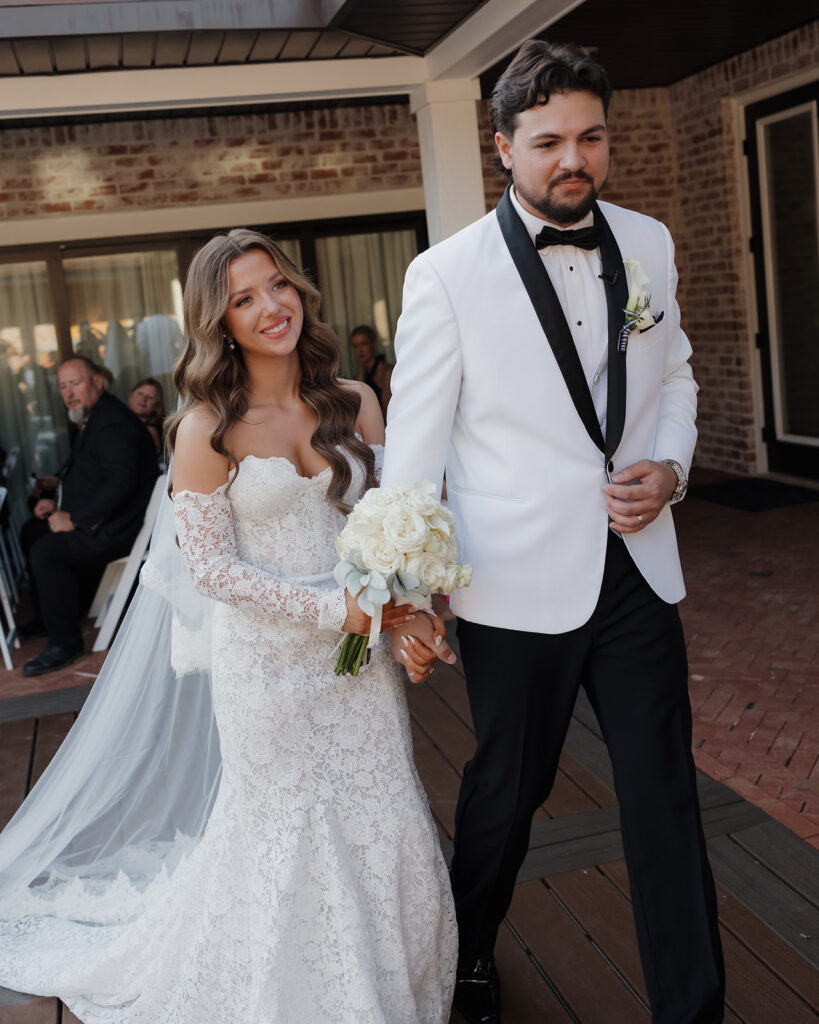 bride and groom walk down the aisle