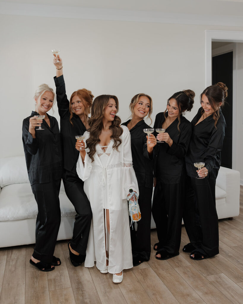 bride and bridesmaids pass champagne