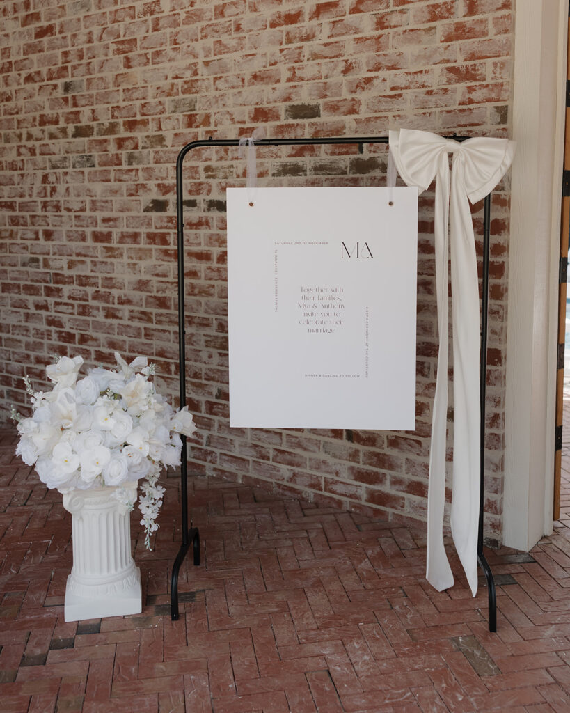 white floral arrangement and wedding sign