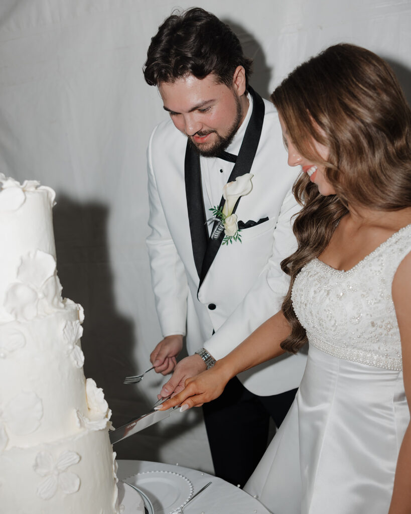 bride and groom cut their cake