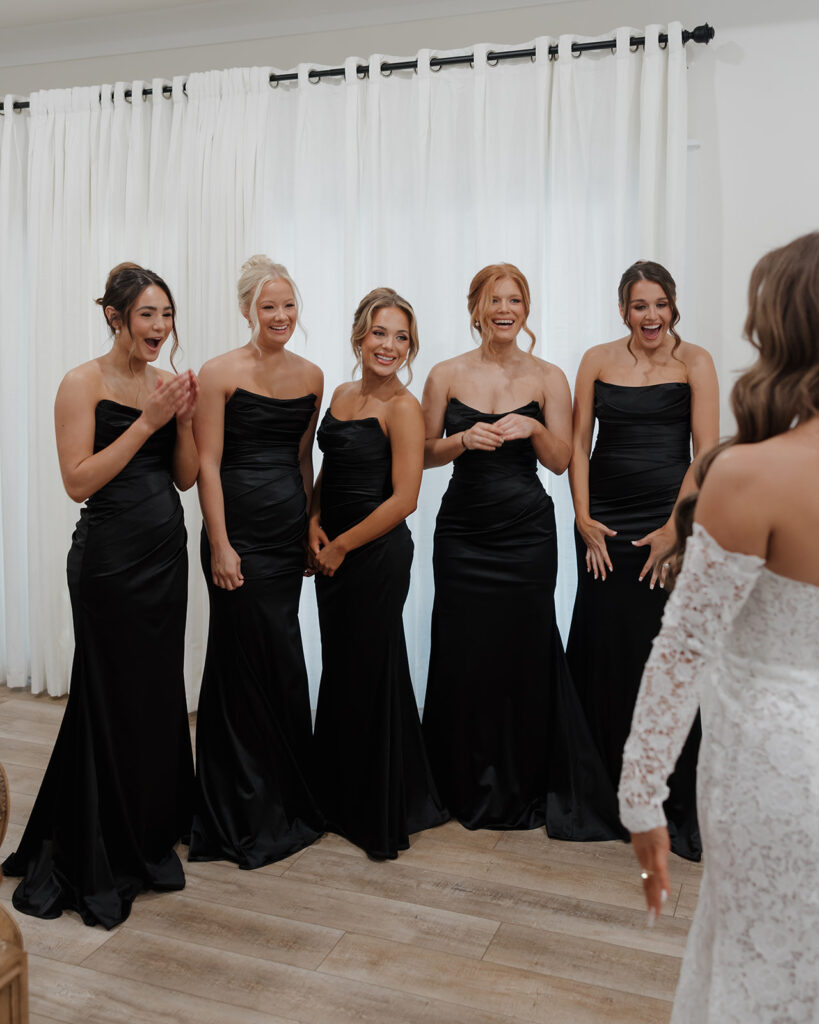 bridesmaids see bride in her wedding dress for the first time