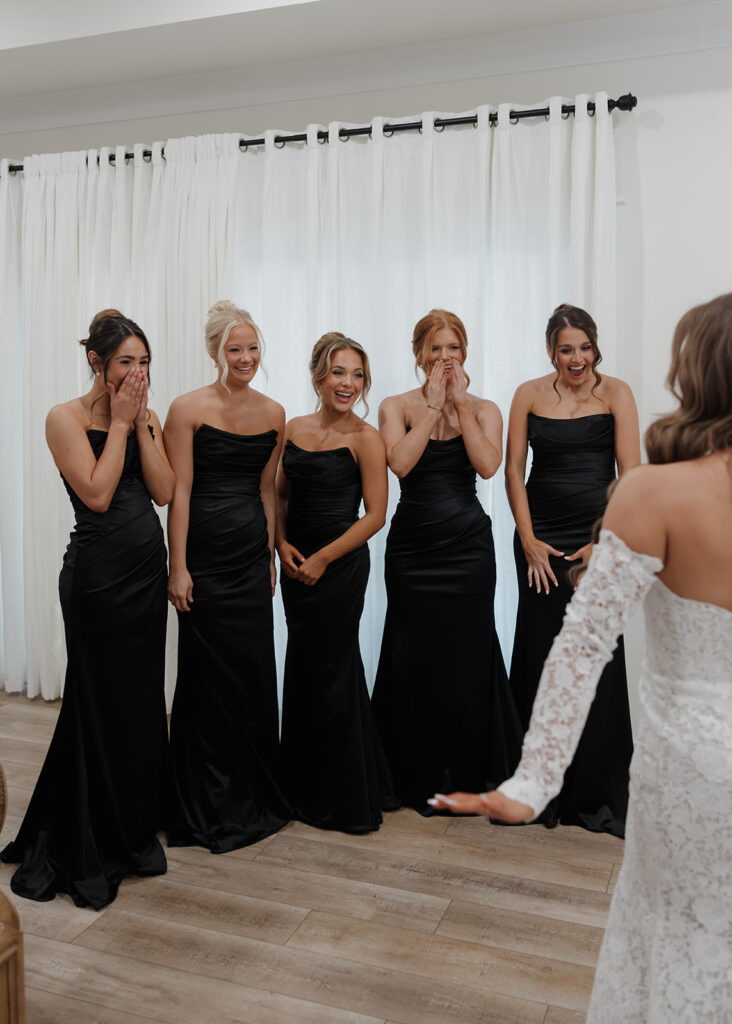 bridesmaids see bride in her wedding dress for the first time