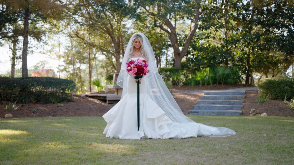 bride smiles at her wedding bouquet