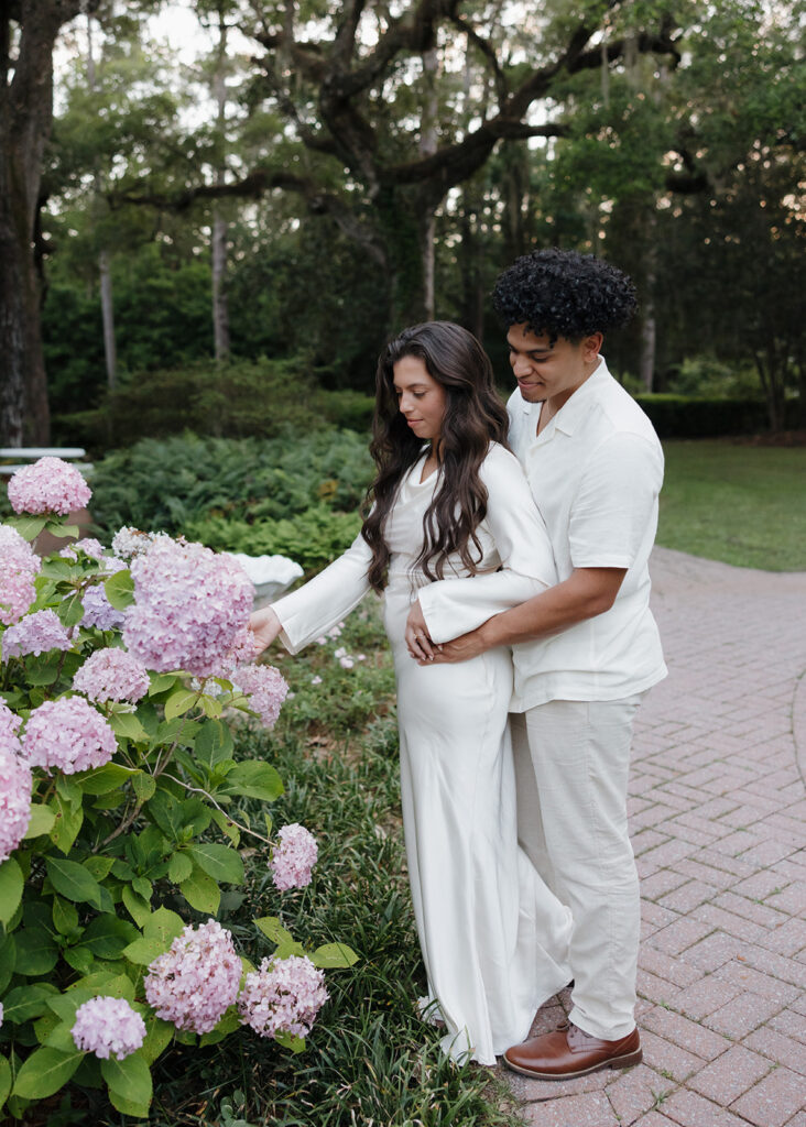 man and woman look at flowers