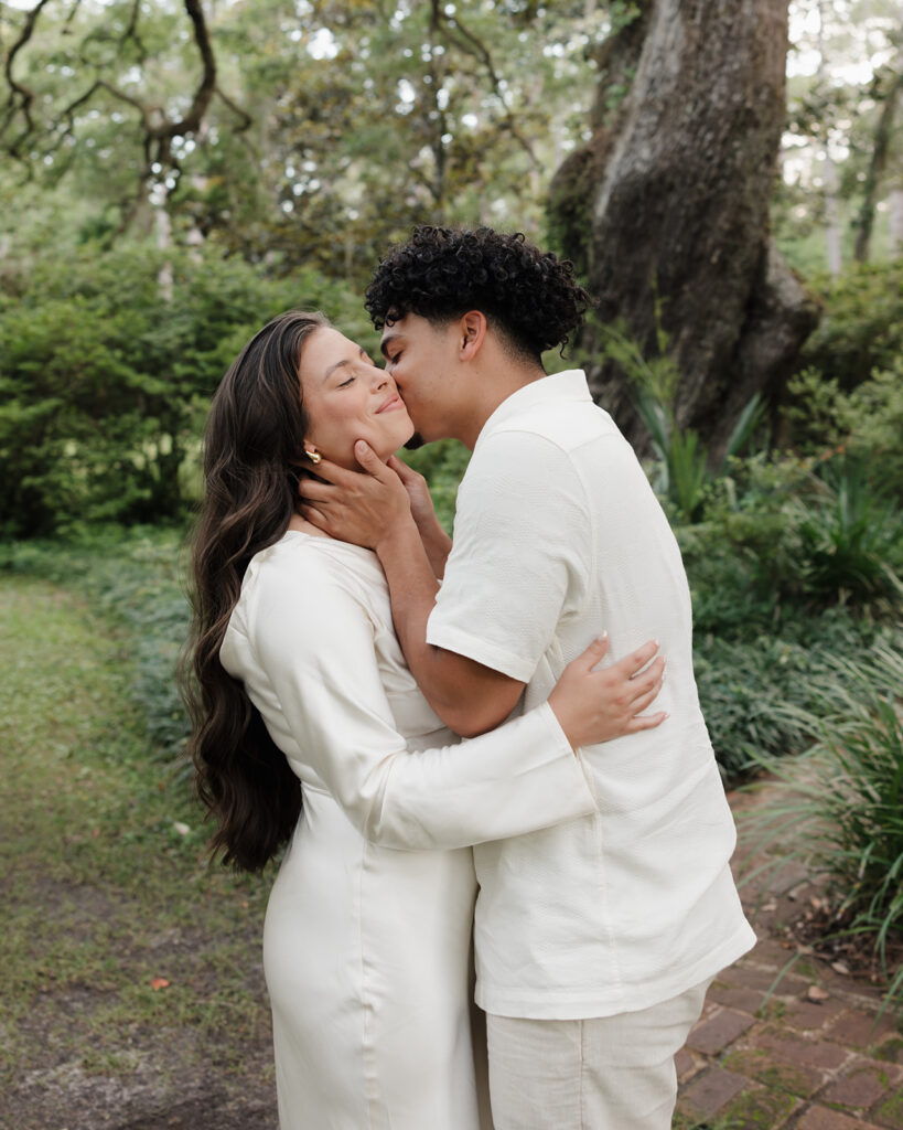 man kisses woman's cheek